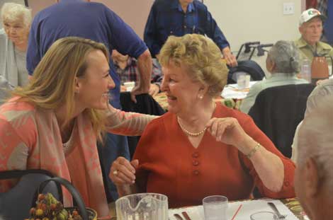 Melissa Holt (left), Sumner Senior Centerâ€™s program director, greets Brigitte Nickerson at the centerâ€™s Oktoberfest.  (Joan Cronk/Senior Scene)
