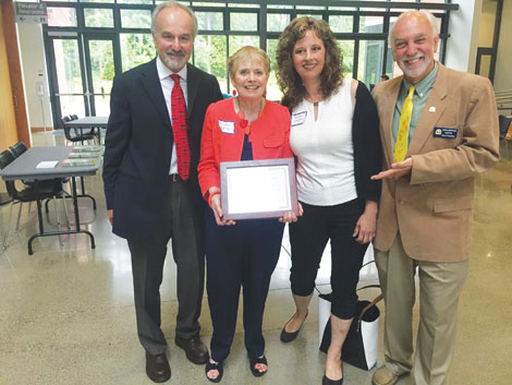 Dr. Roger Landry, Linda Henry, Puyallup City Councilwoman Heather Shadko and Mayor John Hopkins celebrated Puyallup's selection as an AARP/WHO Age-Friendly City.  (Courtesy photo) 