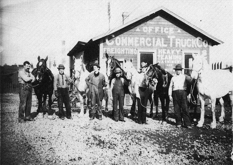 Photo courtesy of Tacoma Public Library. Six unidentified men pose with their horses in front of the offices of the Commercial Truck Co. in the early 1900's.