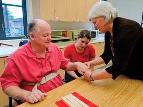 A public patient works with an occupational therapy professor and student in Weyerhaeuser Hall at University of Puget Sound. (Courtesy photo) 