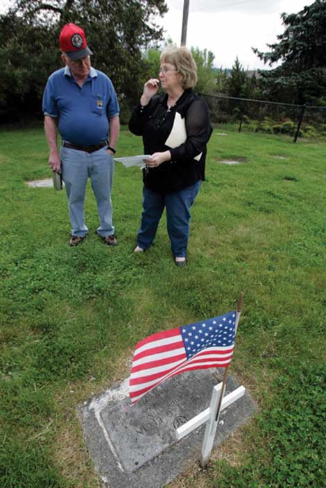 Laurie Porter, manager of Bethany Cemetery, helped connect people in North Dakota with a daughter in Oklahoma of Robert Elgin. Porter is standing at Elginâ€™s gravesite at the cemetery with Doug Korba, a retired Air Force lieutenant colonel who is helping organize a Memorial Day ceremony there. (The Dispatch) 