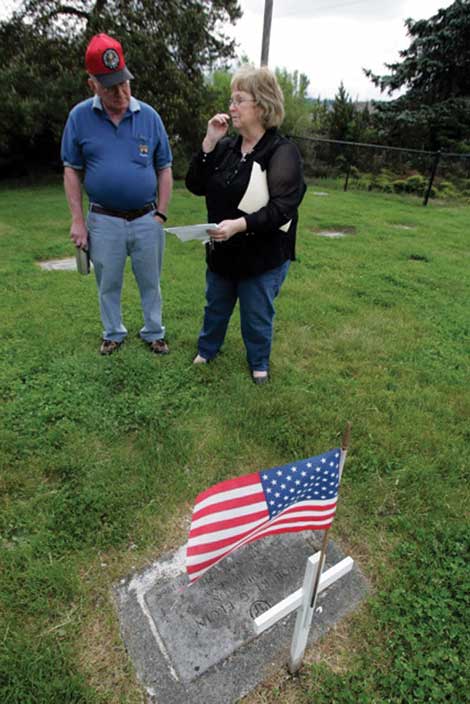 Laurie Porter, manager of Bethany Cemetery, helped connect people in North Dakota with a daughter in Oklahoma of Robert Elgin. Porter is standing at Elgin’s gravesite at the cemetery with Doug Korba, a retired Air Force lieutenant colonel who is helping organize a Memorial Day ceremony there. (The Dispatch)