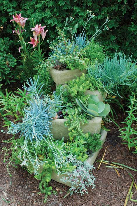 Stacked troughs are an example creative uses of containers for backyard gardening.
