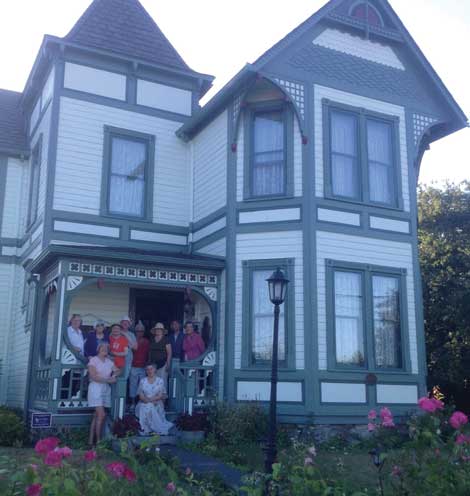 Guests of the Compass Rose bed and breakfast in Coupeville share a moment on the porch with owner Jan Bronson.