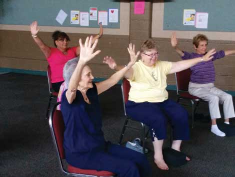 Chair yoga classes like the one taught at University Place Senior Center have enthusiastic participants.