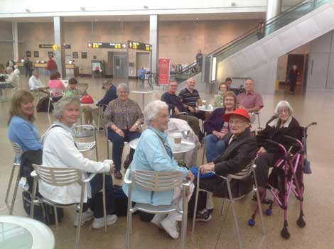 A traveling group waits for a shuttle that will take them to Vancouver, B.C. and the start of a cruise to San Francisco.