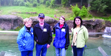 Participants in a zoo walk pause in front of the Sumatran tigers exhibit at Point Defiance Zoo and Aquarium.