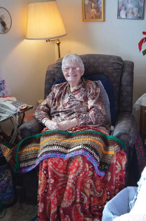 At her home in Sumner, Betty Murray makes scarves by hand for people at a Tacoma homeless shelter. She can always use donations of yarn. (Joan Cronk/Senior Scene) 