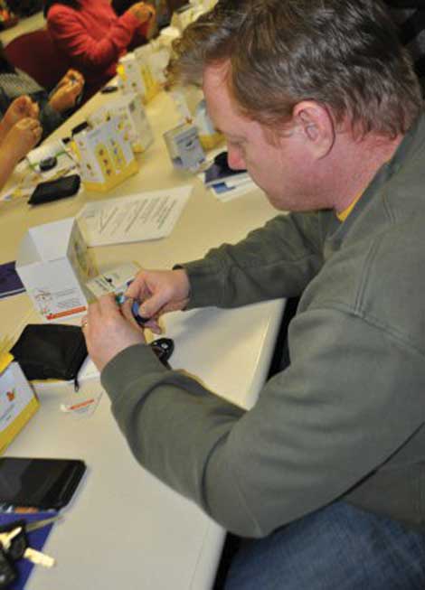Pat Spaulding learns to test his blood sugar level at the Diabetes Care Center's Essentials Class on Jan. 5 at Madigan Army Medical Center. The class gives an overview of diabetes, treatment and how to test blood sugar levels. (Suzanne Ovel/Army Medicine)