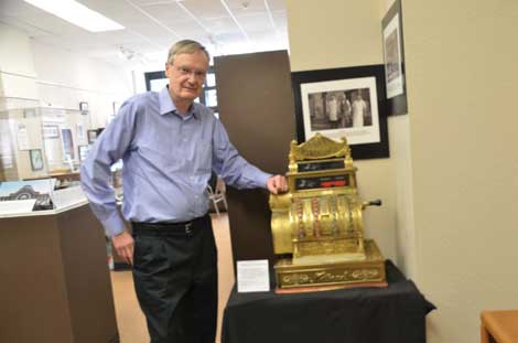 Bill Baarsma, president of Tacoma Historical Society, shows off a 1909 cash register that was once part of a grocery store that brothers Amil and Solomon Zelinsky ran in Tacoma’s Old Town area. “It still works,†said Baarsma. (Joan Cronk/Senior Scene)