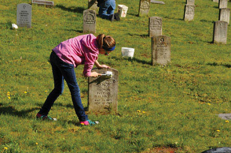 Volunteers are making an annual habit of scrubbing headstones at graves of veterans at Washington Soldiers Home in Orting. (Courtesy photo)