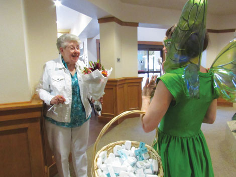 Delta Dental of Washingtonâ€™s mascot, the Tooth Fairy, surprised residents at the Quail Park senior community in Lynnwood with flowers, dental floss and tooth brushes as a reminder of good oral health. 