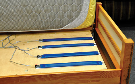 Sensors between bed mattresses and frames monitor heart rate, respiration rate, and overall cardiac activity when a senior is sleeping.