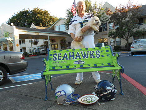 Ed Arnold with the bench he repainted in honor of his favorite football team.