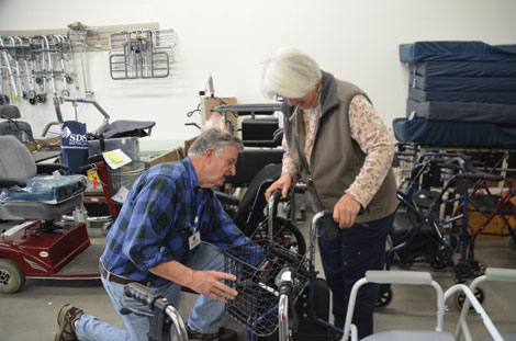 Gene Schwarz helps customer Pat LaFerriere find the right piece of equipment for a friend who has Parkinsonâ€™s Disease. â€œI donâ€™t like to send anything out the door that people donâ€™t know how to use,â€ said Schwarz. (Joan Cronk/for Senior Scene)
