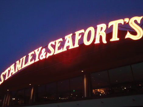The iconic lighted sign of Stanley & Seafortâ€™s beckons diners like a beacon from a hill overlooking Tacoma.